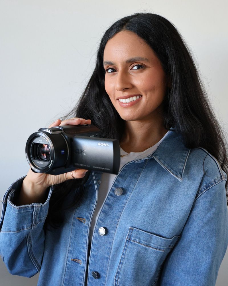 Hanna, founder of Wedding Montage, smiling and holding a Sony 4K camcorder